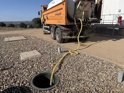 Camión de obra realizando operaciones en depuradora dentro de instalación de saneamiento Trabajo realizado conforme a buenas prácticas y.